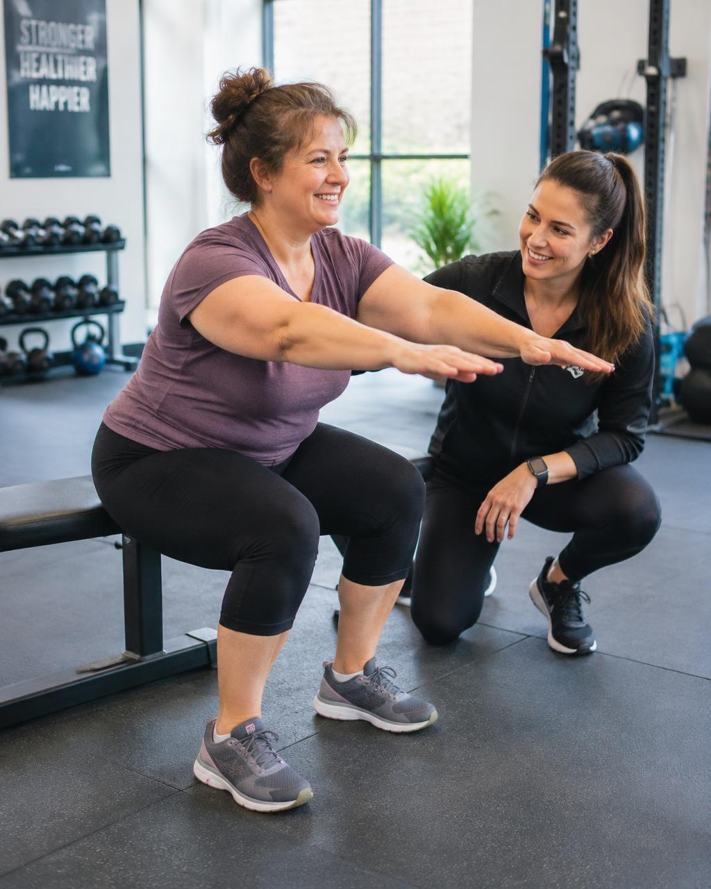 Woman doing a supported squat to a bench